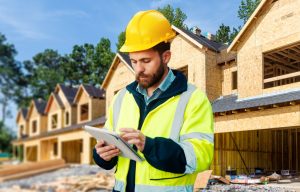 Construction inspector reviewing a tablet at a residential jobsite